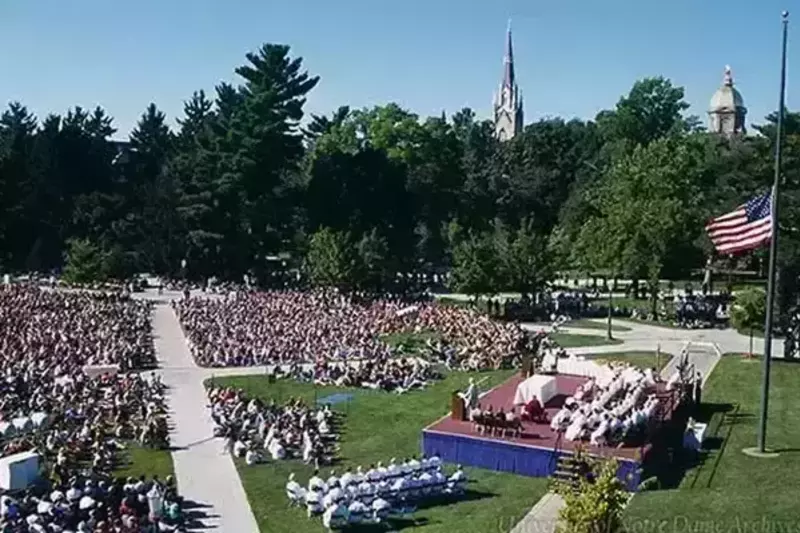 Archive photo of Mass on South Quad after the terrorist attacks. The Dome and Basilica can be seen in the distance, and the US flag is at half-mast behind the stage with the altar.